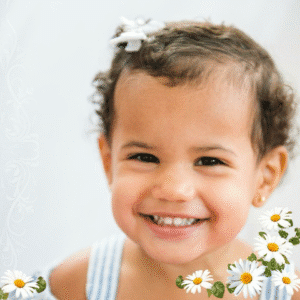Baby girl smiling in early childhood photo, symbolizing innocence, hope, and the future vision of women founders equality.
